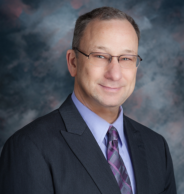 Picture of Troy Patterson wearing glasses and a suit.
