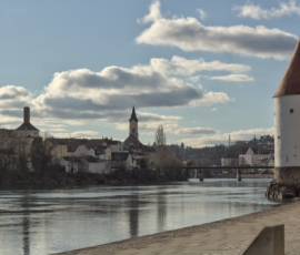 Tower and Bridge with buildings on the other side of the river in Passau, Germany Tower and Bridge with buildings on the other side of the river in Passau, Germany
